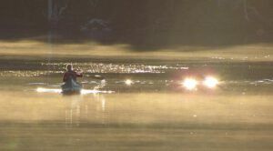 mogens in canoe, sunrise (Moonset, Sunrise)