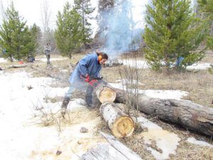 Anne on chainsaw (Having fun on the road at Ginty Creek.)