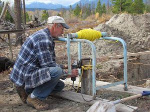 Al grinding top of well (water!)