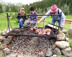 9. Lee with steaks (2015 Precipice Cattle Drive)